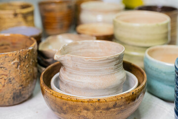 stacks of sets of glazed ceramic bowls
