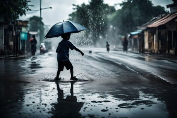 Silhouette of a boy playing with rainy water 