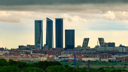 Skyline of the city of Madrid at sunset on a cloudy day with storm clouds.