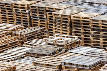 used wooden pallets stacks in outdoors storage, perspective view