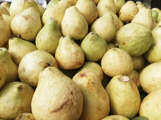 Close-up photo of guavas in fruit shop. Fruits background. Texture green guava.