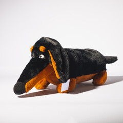 Soft toy black dachshund dog isolated on white background