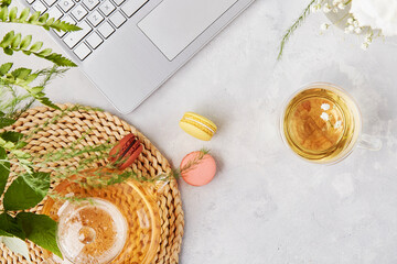 Earphones, herbal tea, laptop. Freelance, remote work concept. Aesthetic tea time, feminine...