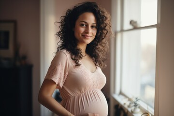 Portrait of a young pregnant woman in her home - obrazy, fototapety, plakaty