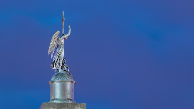 Night Timelapse of Angel Statue on Alexandria Column, Palace Square, Saint Petersburg, Russia. Close-Up View from Moyka River Quay, Illuminated Landmark