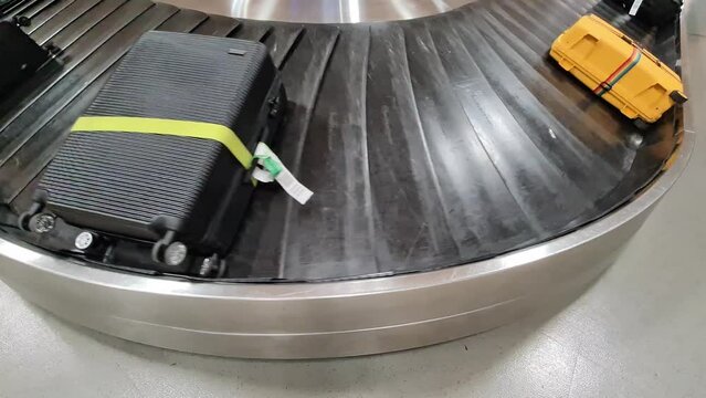 View of a revolving baggage carousel at the airport.
