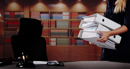 Midsection Of Female Lawyer Carrying Stack Of Ring Binders