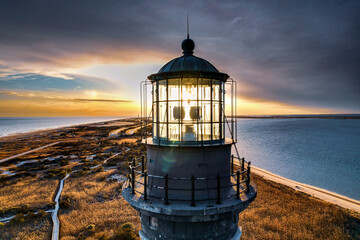 Aerial of Lighthouse at sunset on a beach 