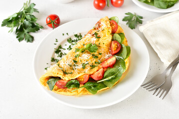 Stuffed omelette with tomatoes and spinach