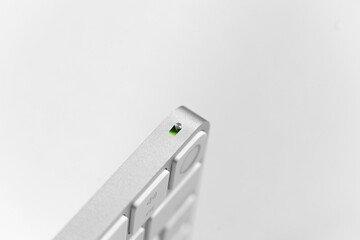 silver keyboard with fingerprint scanner on white background
