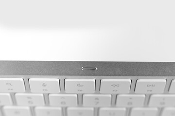 silver keyboard with fingerprint scanner on white background