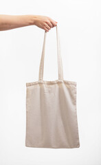 Natural cotton tote bag mockup in hand. Organic textile shopper, totebag