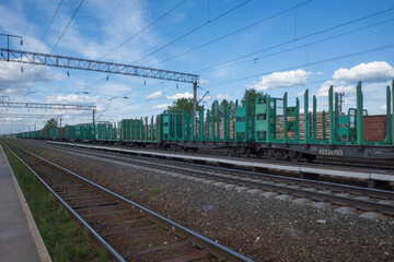 Fototapeta premium railway station with empty freight cars for timber logs