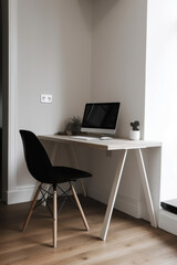 Minimalistic home office interior with clean design, a sleek desk, ergonomic chair, and organized workspace. The simplicity creates focused and aesthetically pleasing environment for productive work.