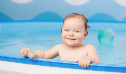 Banner Sport Healthcare in pool for babies. Portrait Cute happy laughing baby girl swimming.