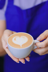 Barista make hot milk for latte art coffee on machine in craft cafe small business