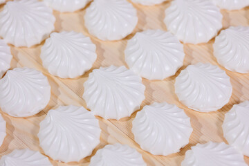 White marshmallows or zephyr in confectionery on conveyor line of sweet food factory
