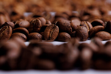 Macro fresh brown roasting coffee beans, warm light toning dark background
