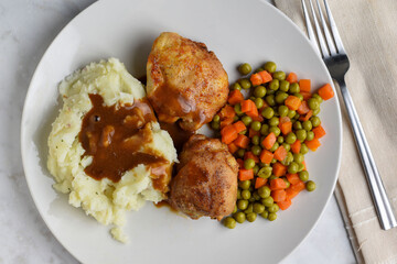 chicken thighs  with mash potatoes gravy and vegetables