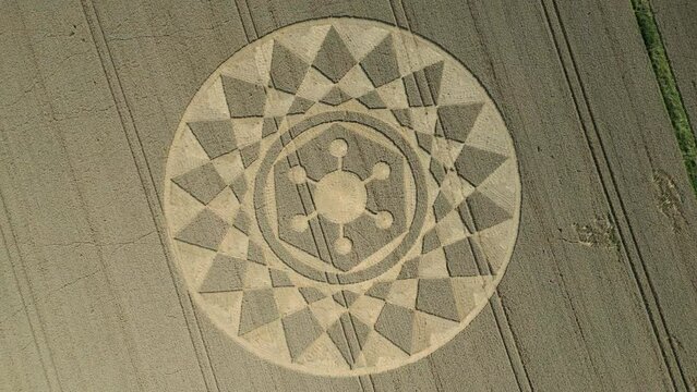 Aerial top down clip of an intricate geometric crop circle formation in a wheat field in Wiltshire, England, UK 