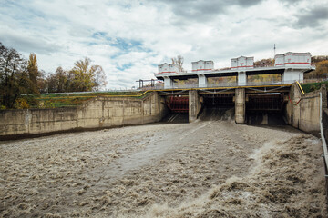 Spillway in Maykop dam, dirty water in river