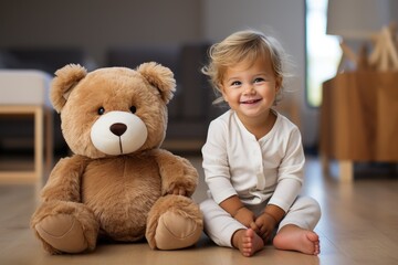 Cute white girl sits next to a teddy bear in the room