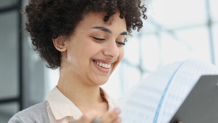 woman in the office looking through paper documents