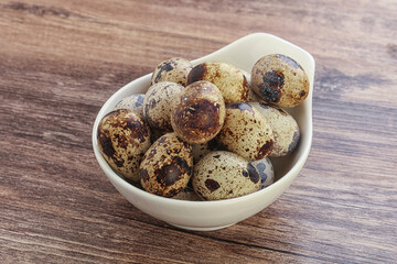 Raw quail eggs heap in the bowl