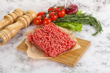 Raw minced beef meat on cutting board