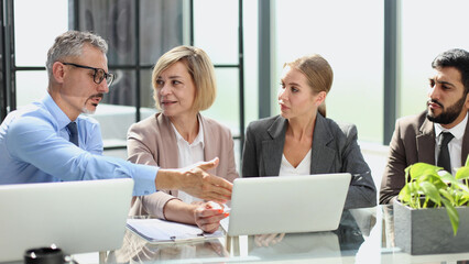 Portrait of creative business team using laptop
