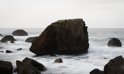 Fototapeta na wymiar Big rock in the atlantic ocean at the shore of Madeira