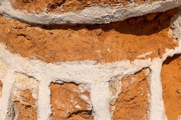 damaged red bricks from the wall of an ancient building