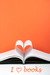 Old open hardback book, page decorate into a heart shape for love in Valentine's. love with open book heart.