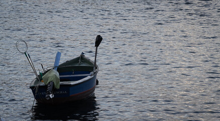 Row boat anchored in the atlantic ocean