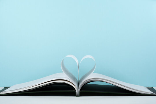 Old open hardback book, page decorate into a heart shape for love in Valentine's. love with open book heart.