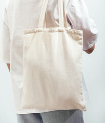Carrying eco textile shopper, cotton tote bag, standing back view