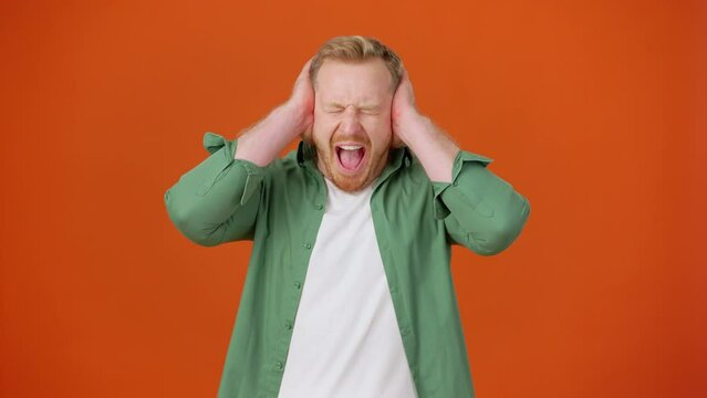 Young man yells and covers ears during scandal with wife