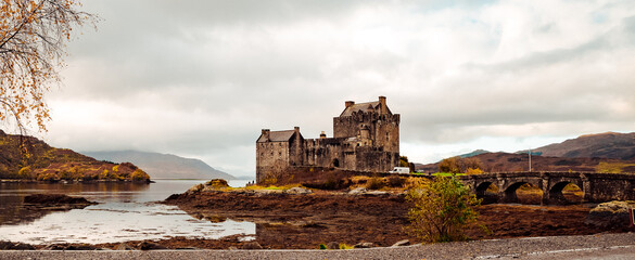 A majestic castle stands tall on a secluded island, surrounded by the tranquil waters of a...