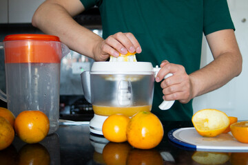 a man preparing a healthy breakfast with orange juice