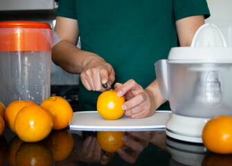 a man preparing a healthy breakfast with orange juice