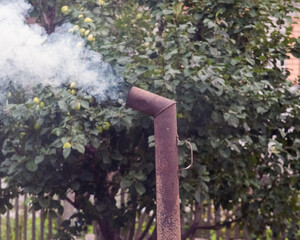 thick smoke from chimney of samovar