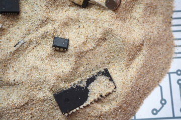 Semiconductor electronic components on the sand. Integrated circuits, chips, diodes. 