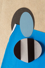 contemporary paper background with oval shapes, folds, and blue tissue paper on brown