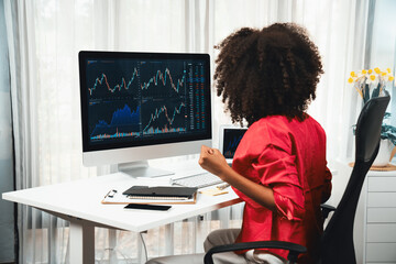 African woman blogger exited with happy face, looking on screen with valued stock market...