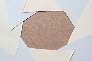 polygonal frame created with overlapping sheets of gray and ivory cut paper pieces