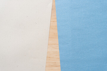 Fototapeta premium beige and blue construction paper sheets on wood (wedge shape)