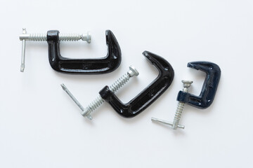 metal C-clamps on blank paper