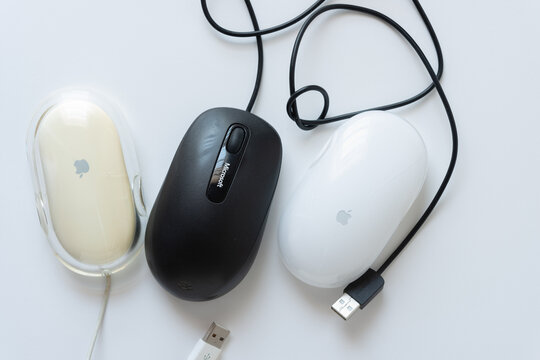 two old apple mice (pro mouse at left and wireless mouse at right) and a malfunctioning microsoft mouse