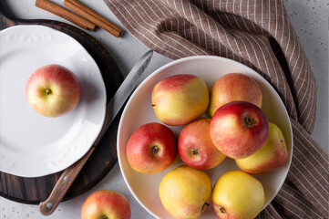 Top view of ripe apples on a plate with a knife and napkin. Selective focus.