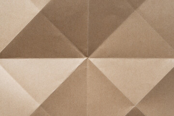 plain brown paper cardboard background featuring geometric or triangular crease lines